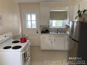 121 Clark Street Milford, CT 06460 - Photo 12 of 35 a kitchen with a sink stove and refrigerator