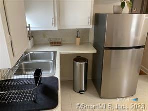 121 Clark Street Milford, CT 06460 - Photo 14 of 35 a kitchen with a refrigerator and a sink