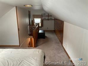 121 Clark Street Milford, CT 06460 - Photo 26 of 35 a view of a hallway to a room with wooden floor
