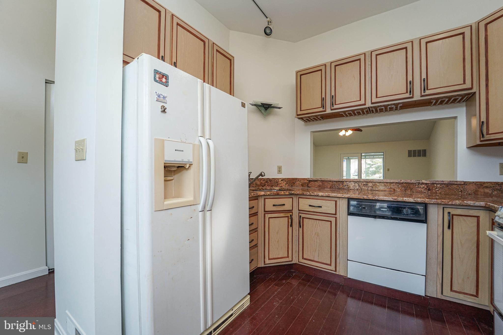 7009 Bridgepointe Drive Chester, MD 21619 - Photo 21 of 41 a kitchen with stainless steel appliances granite countertop a refrigerator and cabinets