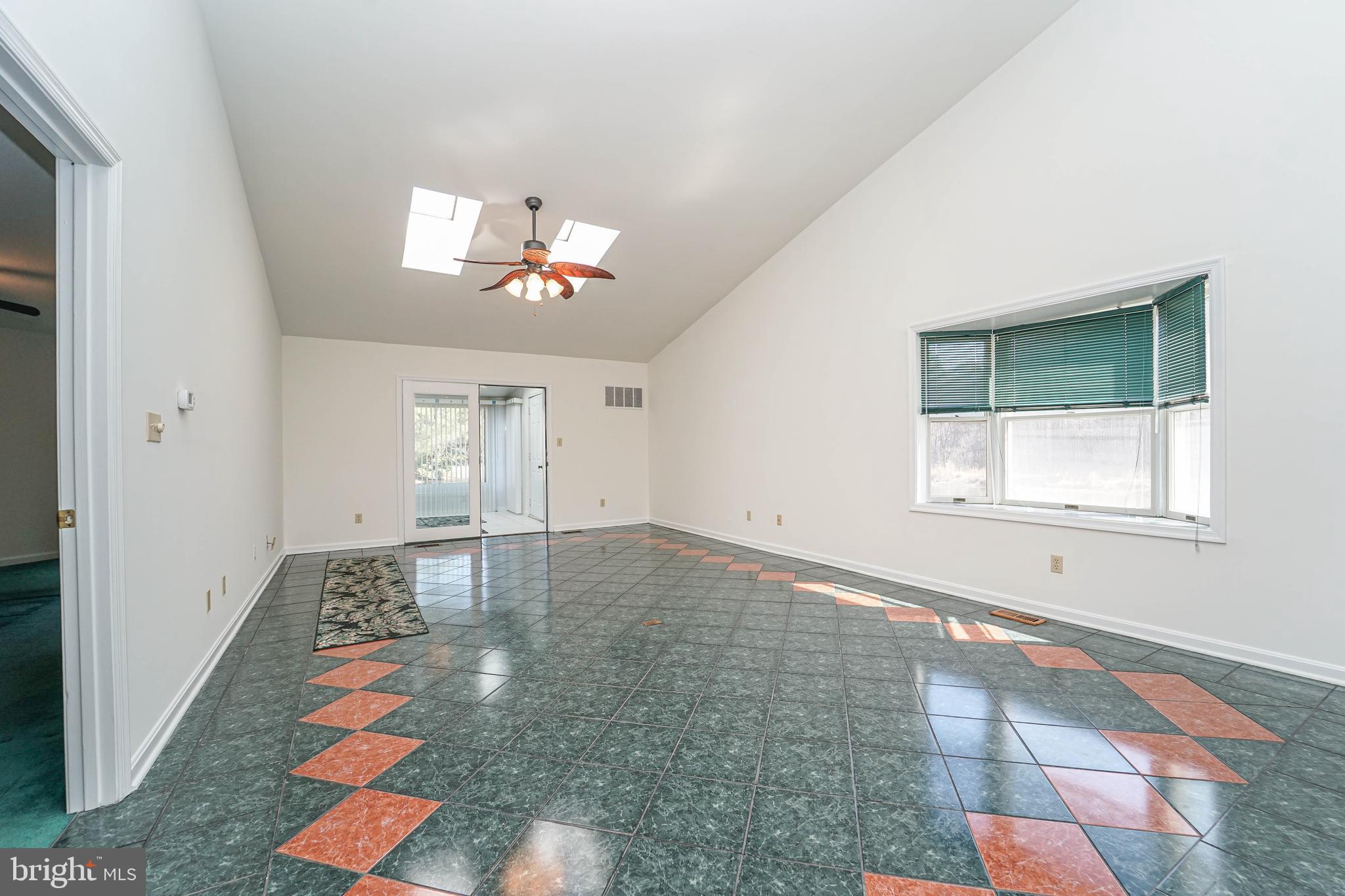 7009 Bridgepointe Drive Chester, MD 21619 - Photo 23 of 41 a view of an empty room with window and chandelier fan