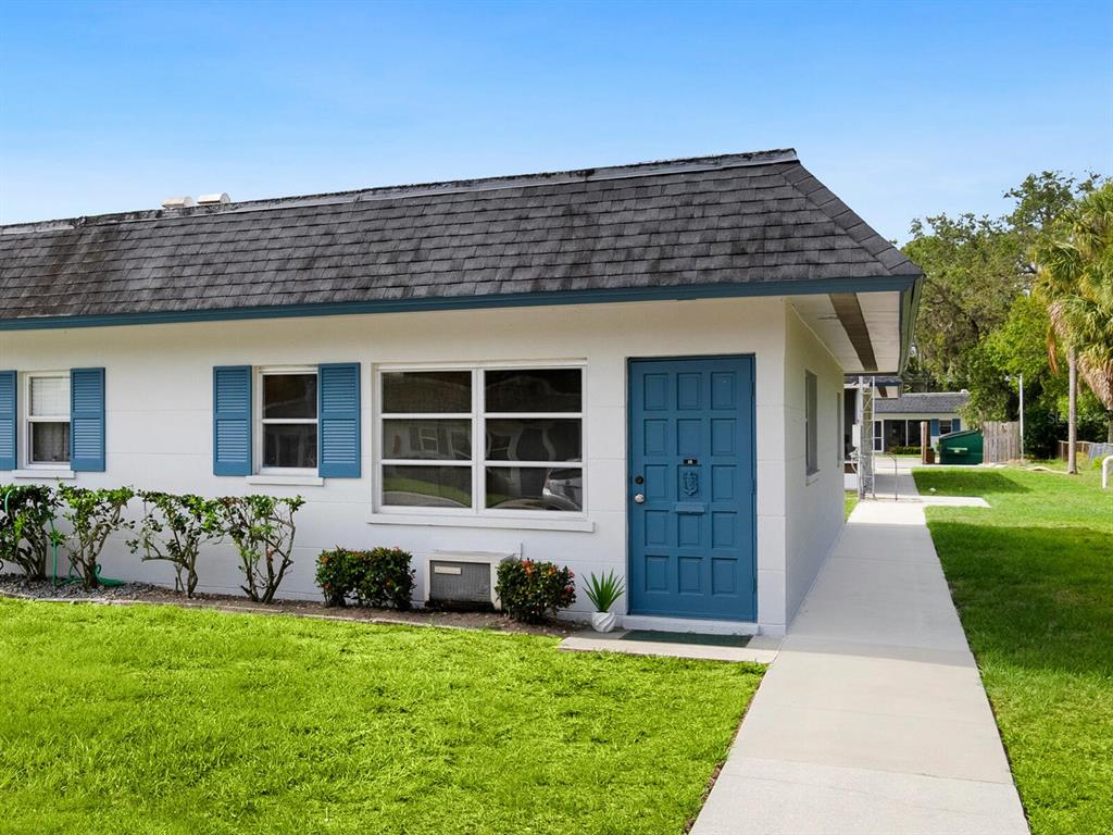 4444 Swift Road, Unit 35 Sarasota, FL 34231 - Photo 1 of 1 a front view of a house with a garden