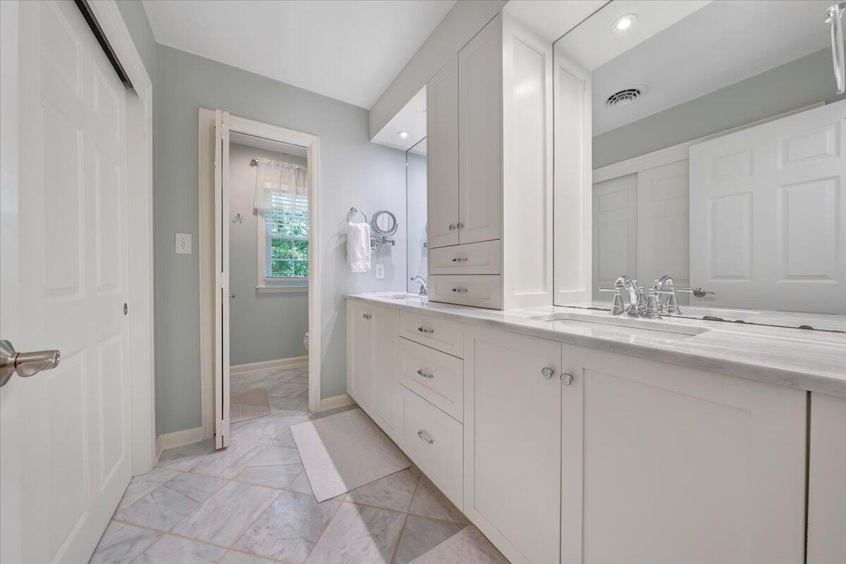 5249 Falcon Ridge Road Roanoke, VA 24018 - Photo 27 of 58 a spacious bathroom with a granite countertop sink and a mirror