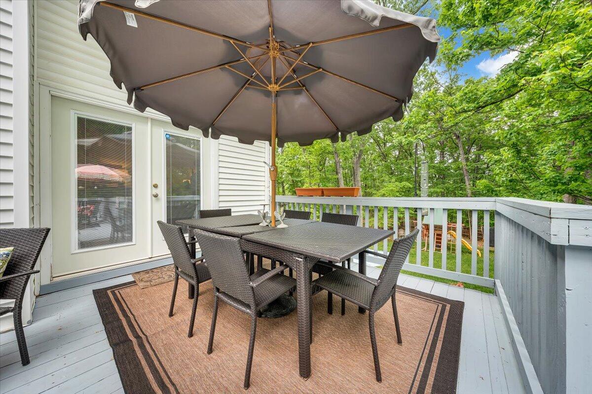 5249 Falcon Ridge Road Roanoke, VA 24018 - Photo 47 of 58 a patio with wooden floor a yard a table and chairs