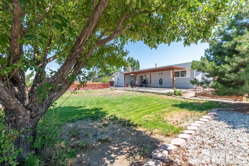 8605 Channel Reno, NV 89506 - Photo 20 of 21 a view of house with backyard and a garden