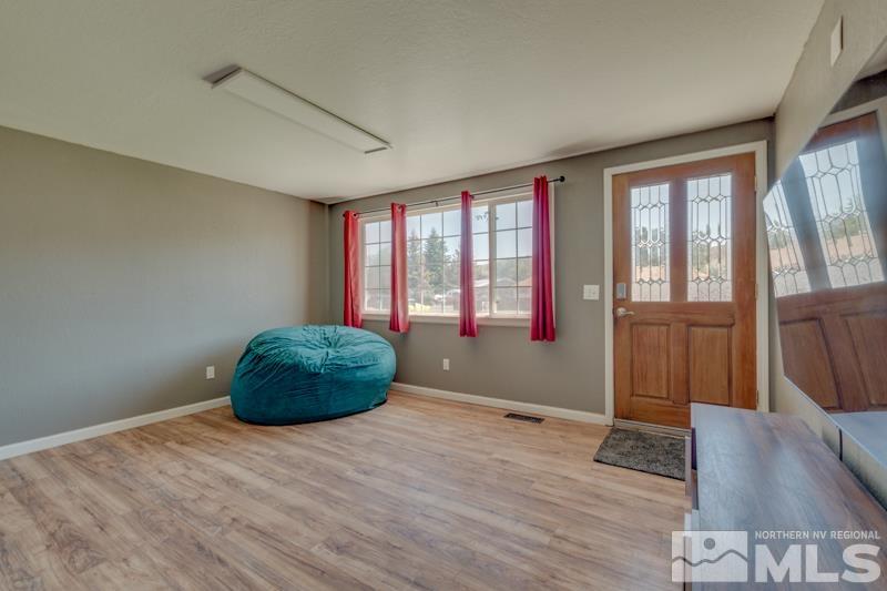 8605 Channel Reno, NV 89506 - Photo 4 of 21 an empty room with wooden floor and windows