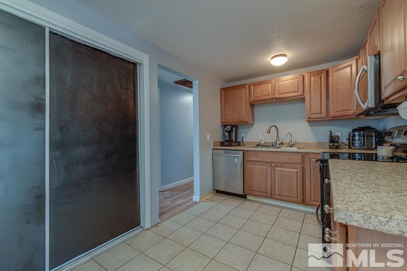 8605 Channel Reno, NV 89506 - Photo 8 of 21 a kitchen with a sink a refrigerator and cabinets