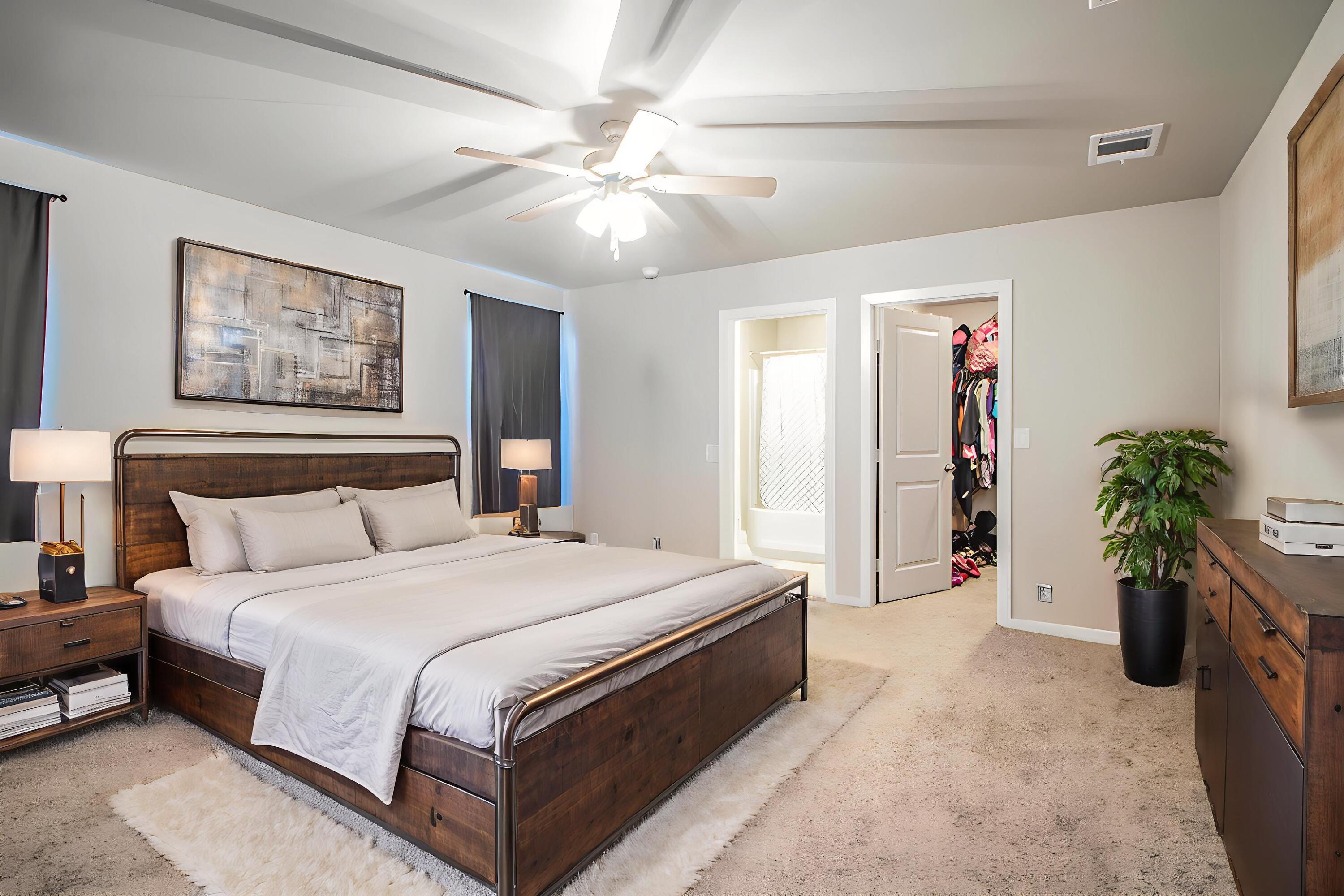 2908 Waverly Avenue Lubbock, TX 79407 - Photo 11 of 22 a spacious bedroom with a bed and a chandelier