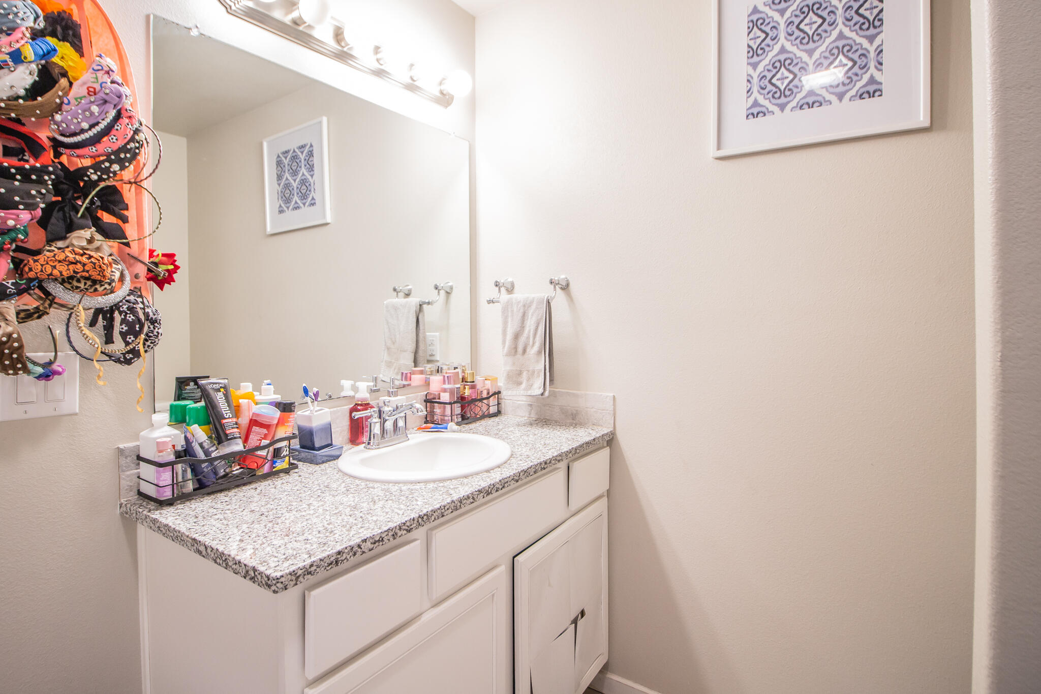 2908 Waverly Avenue Lubbock, TX 79407 - Photo 12 of 22 a bathroom with a granite countertop sink and a mirror