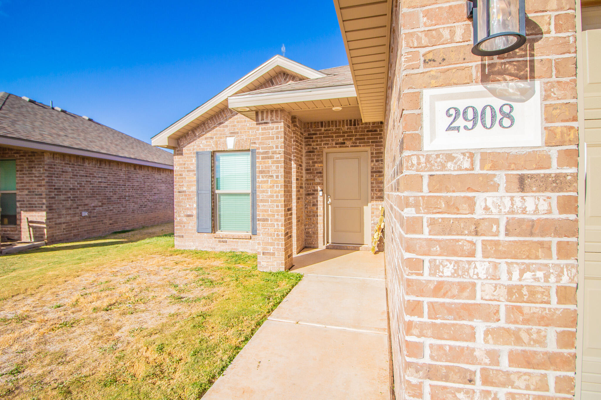 2908 Waverly Avenue Lubbock, TX 79407 - Photo 4 of 22 a view of a brick house with a large windows