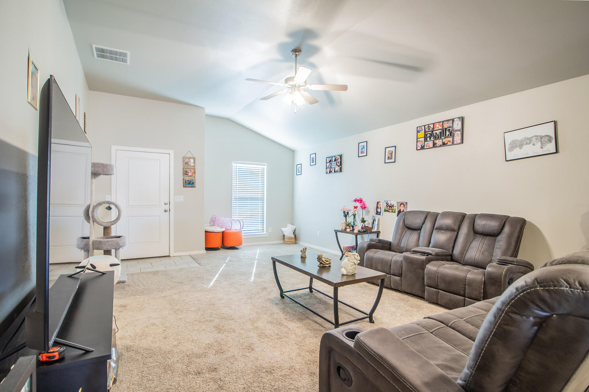 2908 Waverly Avenue Lubbock, TX 79407 - Photo 5 of 22 a living room with furniture and a flat screen tv