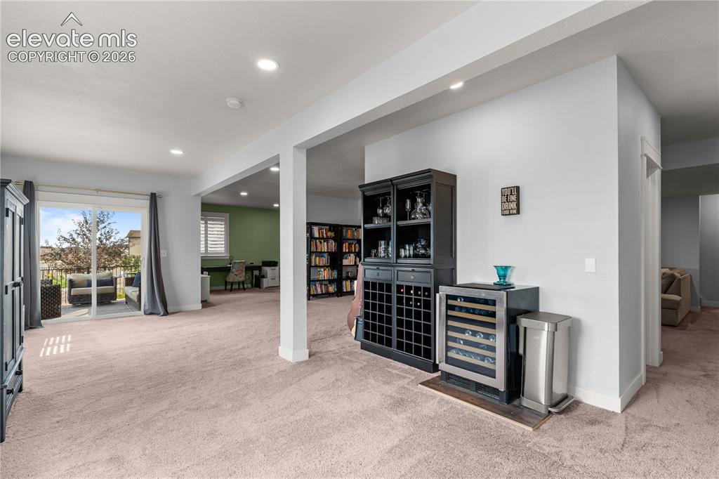 12781 Granite Ridge Drive Peyton, CO 80831 - Photo 28 of 41 Could accomodate game tables and more. The tall ceilings are bright and airy.