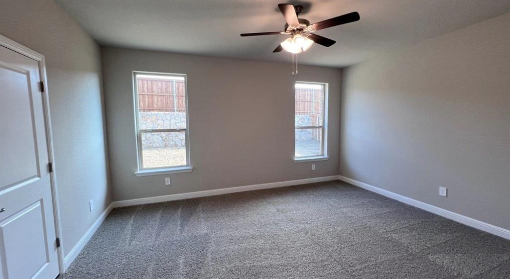 153 Medina Lane Rhome, TX 76078 - Photo 5 of 21 an empty room with windows and fan