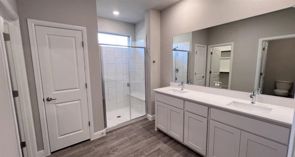 153 Medina Lane Rhome, TX 76078 - Photo 6 of 21 a bathroom with a double vanity sink and mirror with shower