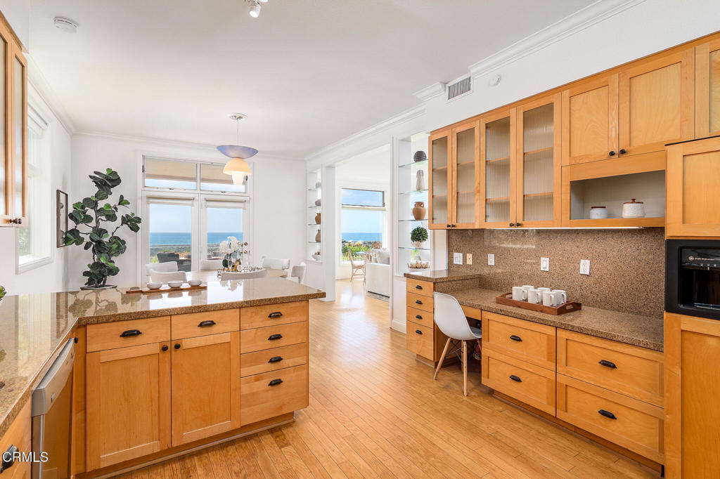 101 Rios Court Solana Beach, CA 92075 - Photo 19 of 67 a kitchen with kitchen island granite countertop a sink and cabinets