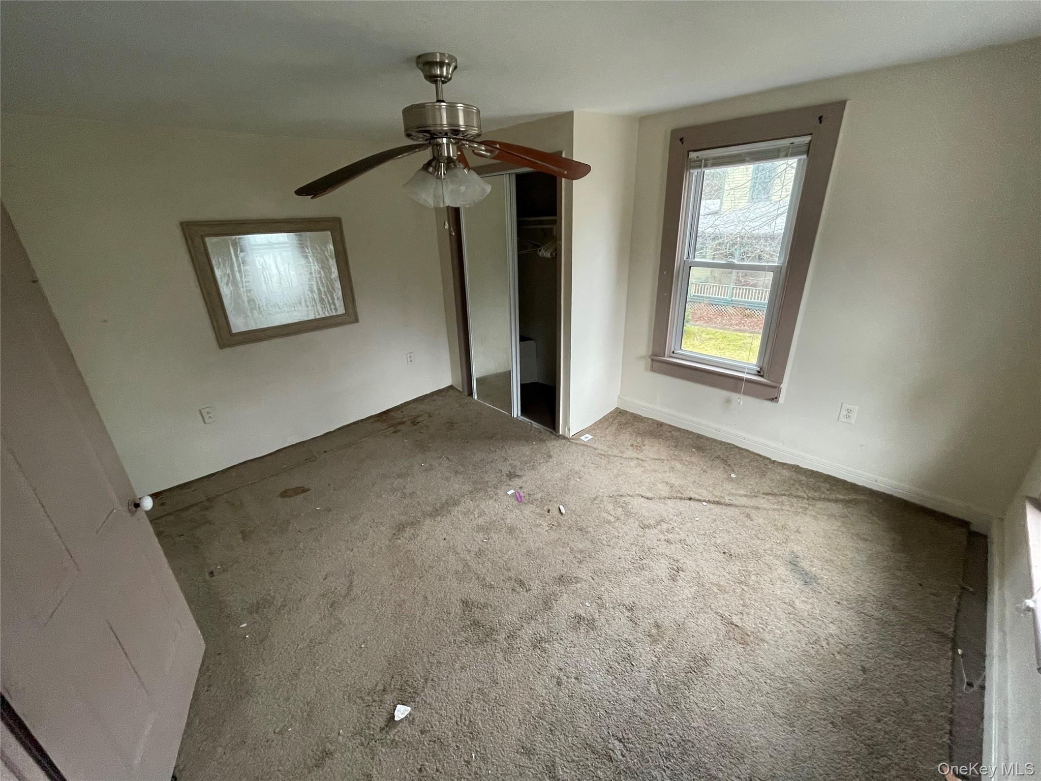 865 North Branch Road Callicoon, NY 12766 - Photo 10 of 15 Unfurnished bedroom with a closet, ceiling fan, and carpet flooring