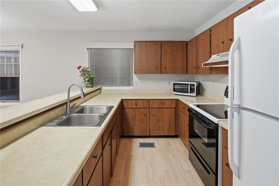 1951 West Shell Lane Vero Beach, FL 32963 - Photo 15 of 35 a kitchen with a sink a stove and cabinets