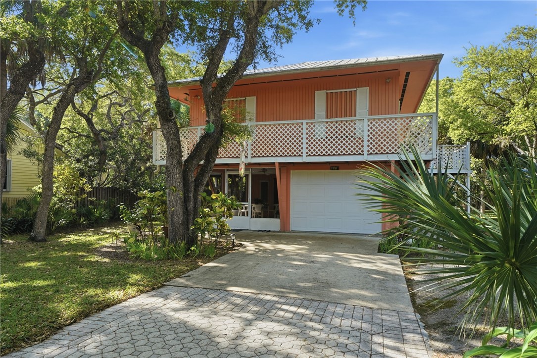 1951 West Shell Lane Vero Beach, FL 32963 - Photo 2 of 35 a front view of a house with a yard and garage