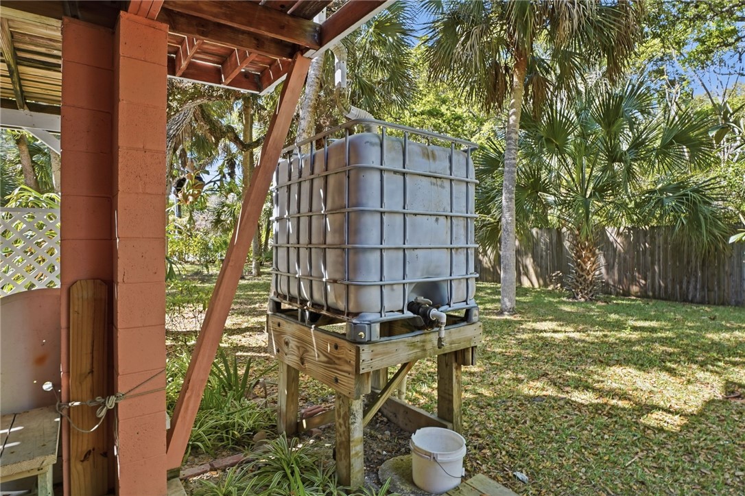 1951 West Shell Lane Vero Beach, FL 32963 - Photo 27 of 35 a backyard of a house with table and chairs and wooden fence