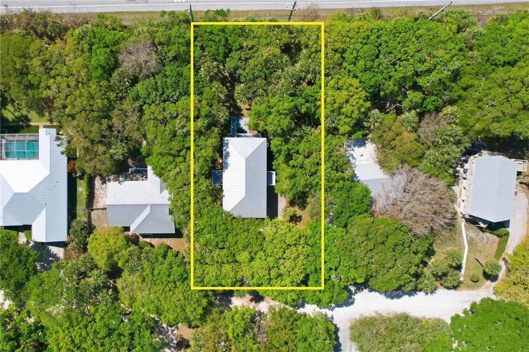 1951 West Shell Lane Vero Beach, FL 32963 - Photo 31 of 35 an aerial view of a house with a yard and lake view