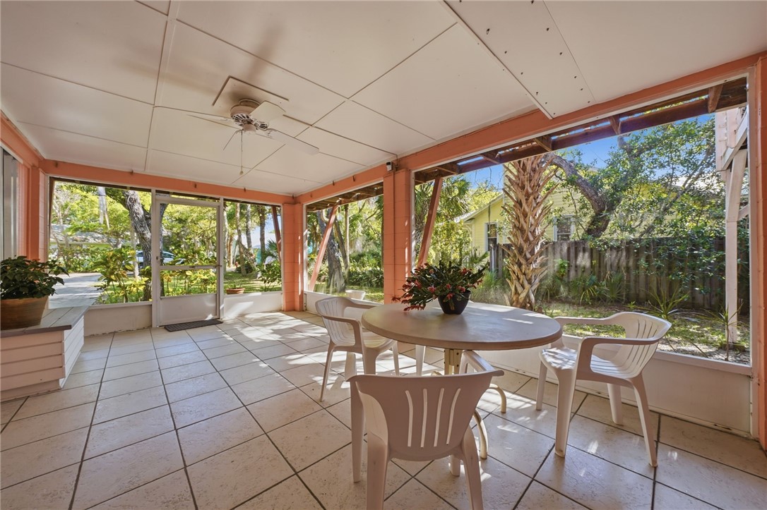 1951 West Shell Lane Vero Beach, FL 32963 - Photo 4 of 35 a view of a dining room with furniture large windows and wooden floor