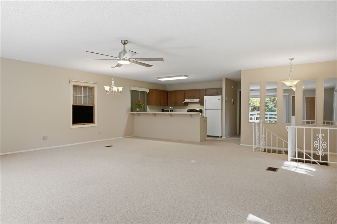 1951 West Shell Lane Vero Beach, FL 32963 - Photo 9 of 35 a view of a livingroom with a kitchen and a stove
