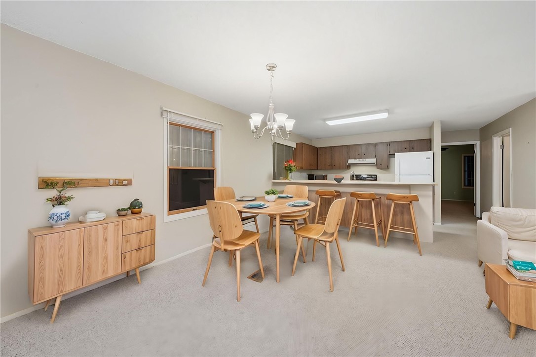1951 West Shell Lane Vero Beach, FL 32963 - Photo 10 of 35 a dining room with furniture a rug and a kitchen