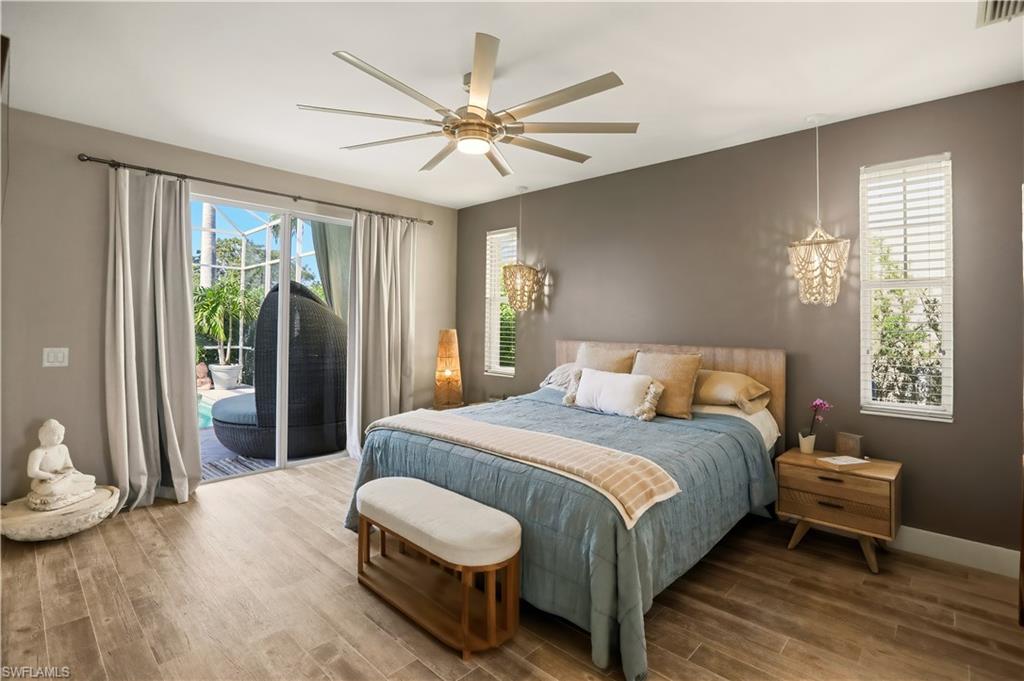 80 Delbrook Way Marco Island, FL 34145 - Photo 16 of 49 Bedroom with wood finished floors, access to exterior, and a ceiling fan
