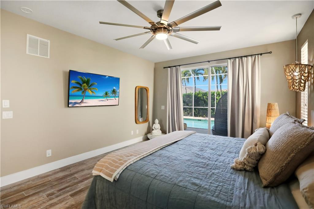 80 Delbrook Way Marco Island, FL 34145 - Photo 18 of 49 Bedroom featuring access to outside, wood finished floors, and ceiling fan