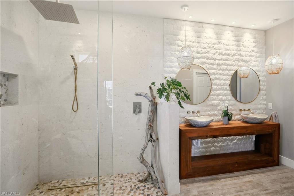 80 Delbrook Way Marco Island, FL 34145 - Photo 19 of 49 Bathroom with a marble finish shower and double vanity