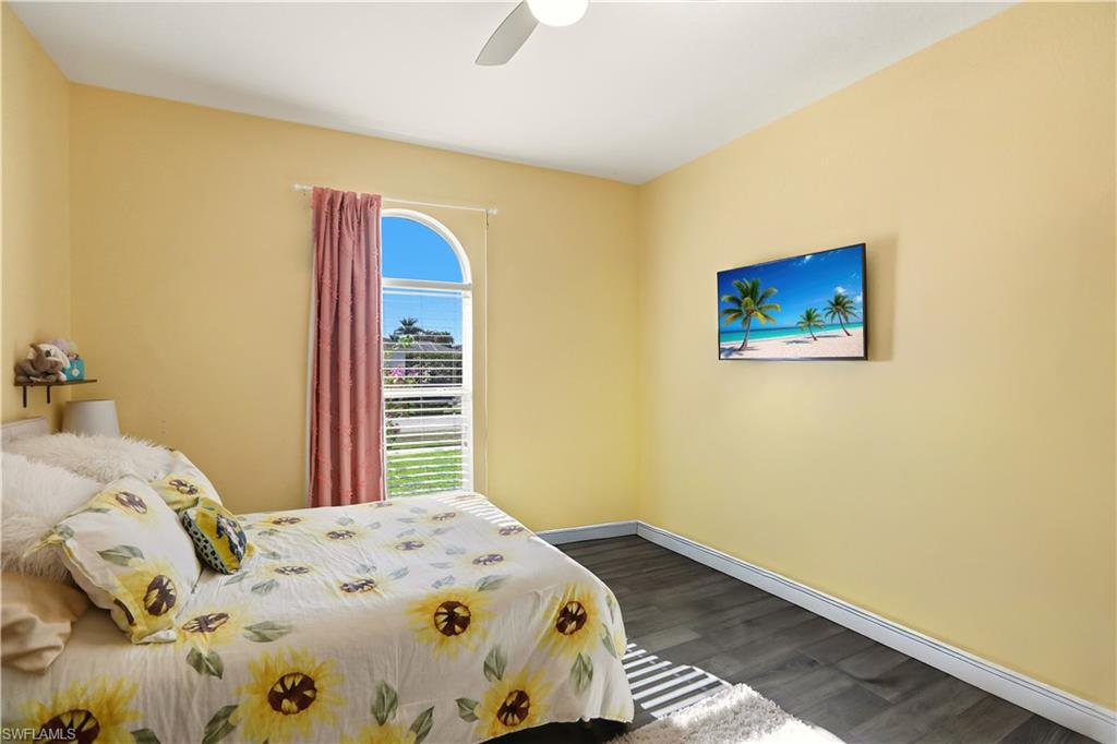 80 Delbrook Way Marco Island, FL 34145 - Photo 23 of 49 Bedroom featuring dark wood-style floors and a ceiling fan