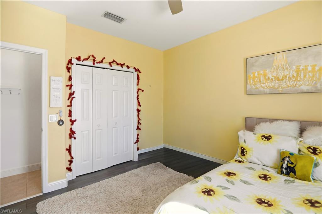 80 Delbrook Way Marco Island, FL 34145 - Photo 24 of 49 Bedroom with dark wood-style flooring, a closet, and a ceiling fan