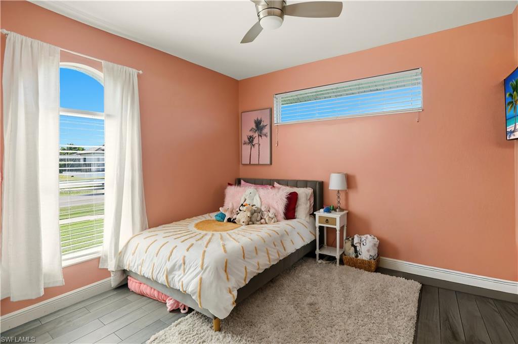 80 Delbrook Way Marco Island, FL 34145 - Photo 25 of 49 Bedroom featuring ceiling fan, multiple windows, and wood finished floors