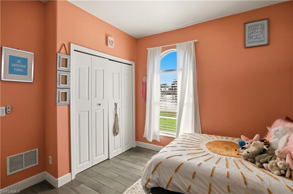 80 Delbrook Way Marco Island, FL 34145 - Photo 26 of 49 Bedroom featuring wood finish floors and a closet