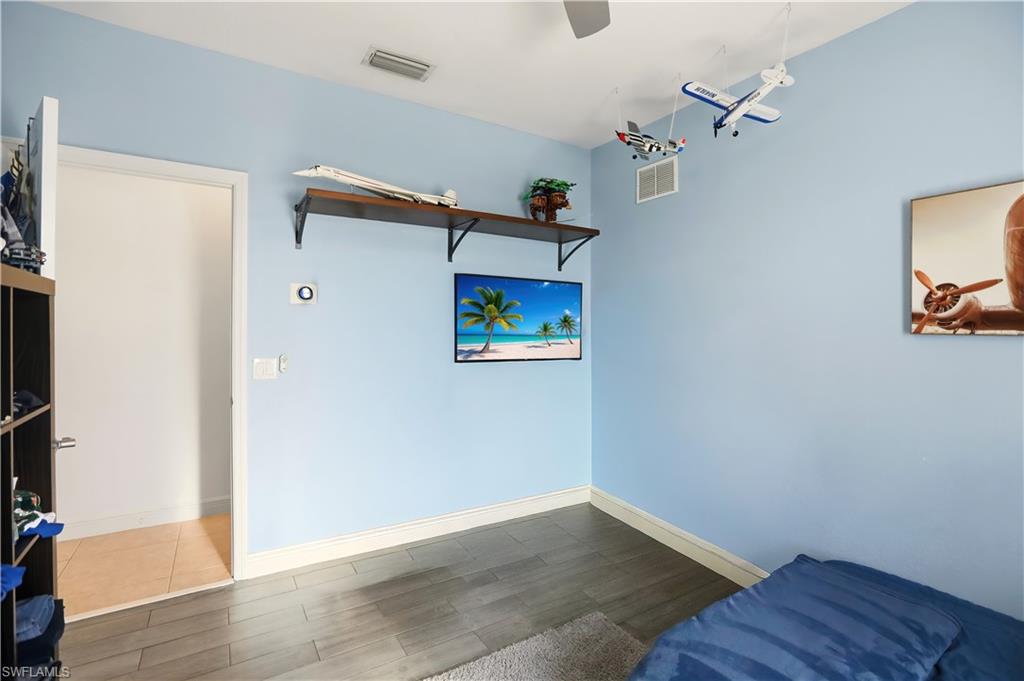 80 Delbrook Way Marco Island, FL 34145 - Photo 30 of 49 Living area featuring wood finished floors and baseboards