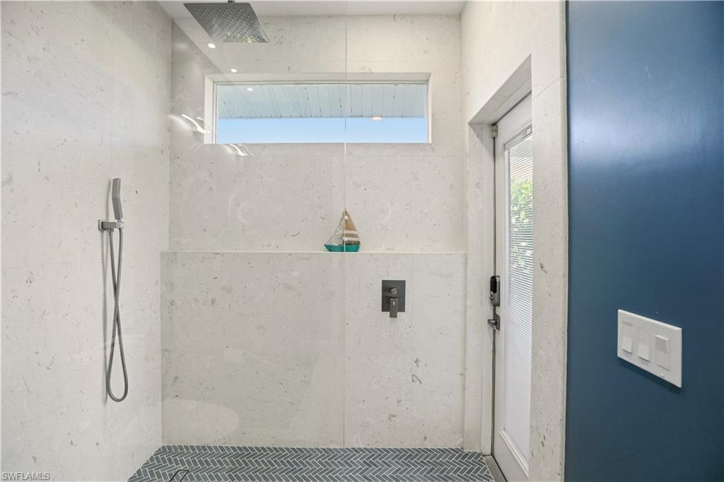 80 Delbrook Way Marco Island, FL 34145 - Photo 32 of 49 Full bathroom with a tile shower and healthy amount of natural light