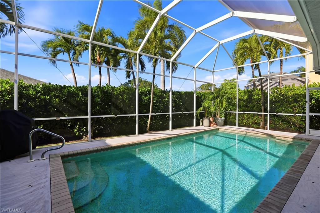 80 Delbrook Way Marco Island, FL 34145 - Photo 36 of 49 Outdoor pool featuring a lanai, a grill, and a sunroom