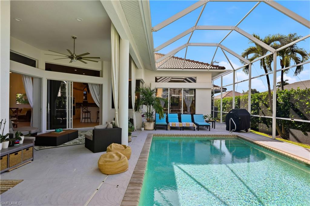 80 Delbrook Way Marco Island, FL 34145 - Photo 37 of 49 Outdoor pool featuring a lanai, a grill, and a sunroom