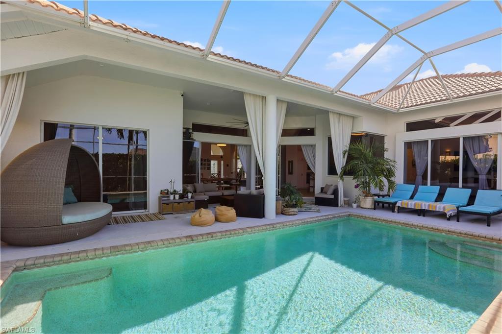 80 Delbrook Way Marco Island, FL 34145 - Photo 38 of 49 Swimming pool featuring an outdoor hangout area, a sunroom, a patio, and glass enclosure