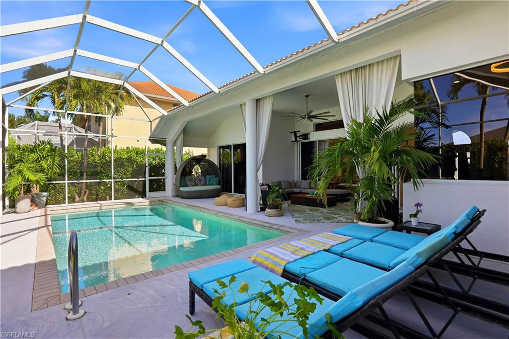 80 Delbrook Way Marco Island, FL 34145 - Photo 39 of 49 Swimming pool with a sunroom, an outdoor living space, a patio, and glass enclosure