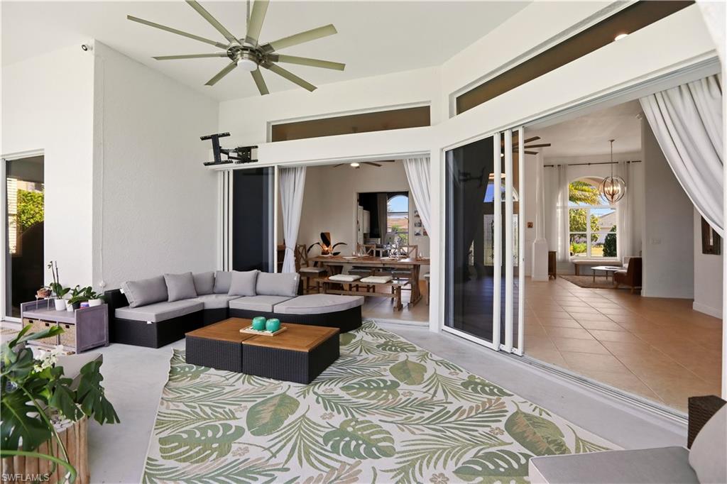 80 Delbrook Way Marco Island, FL 34145 - Photo 42 of 49 Living area featuring a chandelier, ceiling fan, and a high ceiling