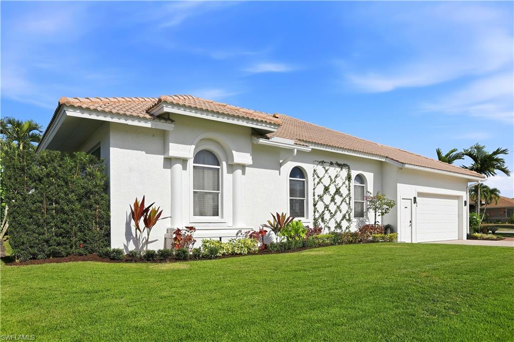 80 Delbrook Way Marco Island, FL 34145 - Photo 45 of 49 View of front of property with a front lawn, a tiled roof, and stucco siding