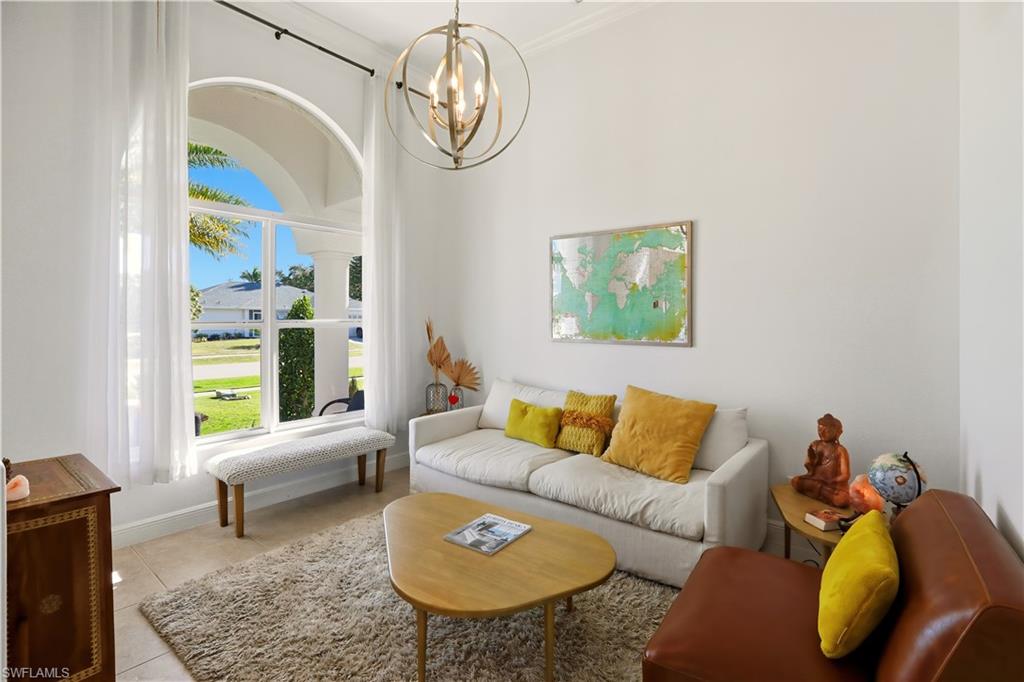 80 Delbrook Way Marco Island, FL 34145 - Photo 6 of 49 Living area featuring a chandelier and tile patterned flooring