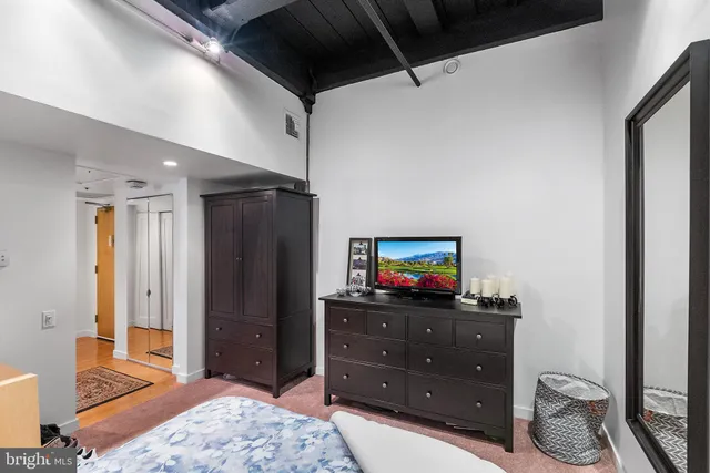 a bedroom with a bed and a dresser in it