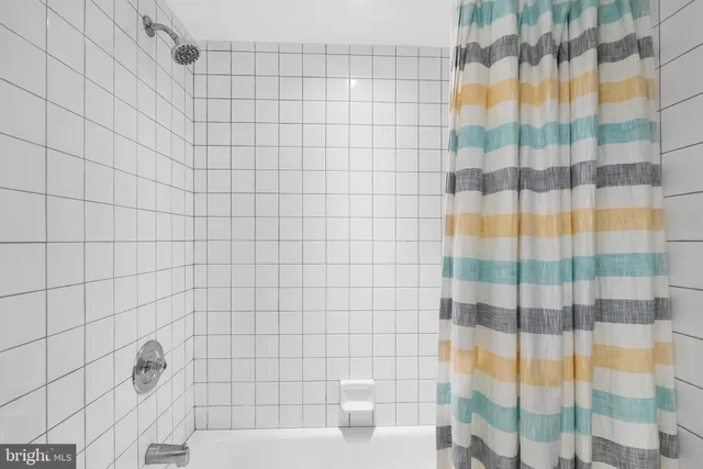 a bathroom with a bathtub and shower