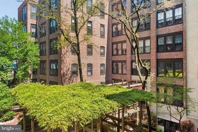 a view of an house with backyard and sitting area