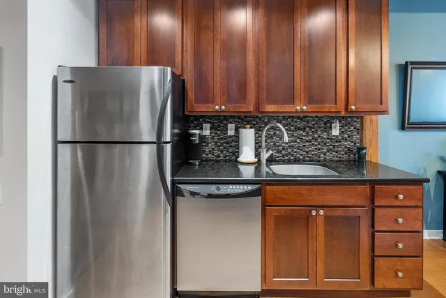 a white refrigerator freezer sitting inside of a kitchen