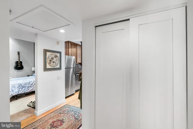 a view of a bedroom with bed and walk in closet