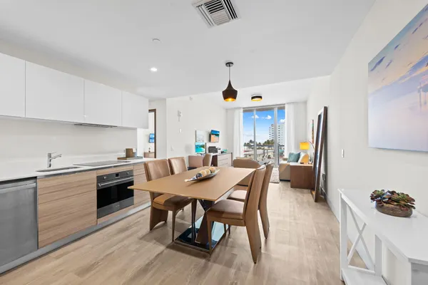 a kitchen with granite countertop white cabinets and stainless steel appliances