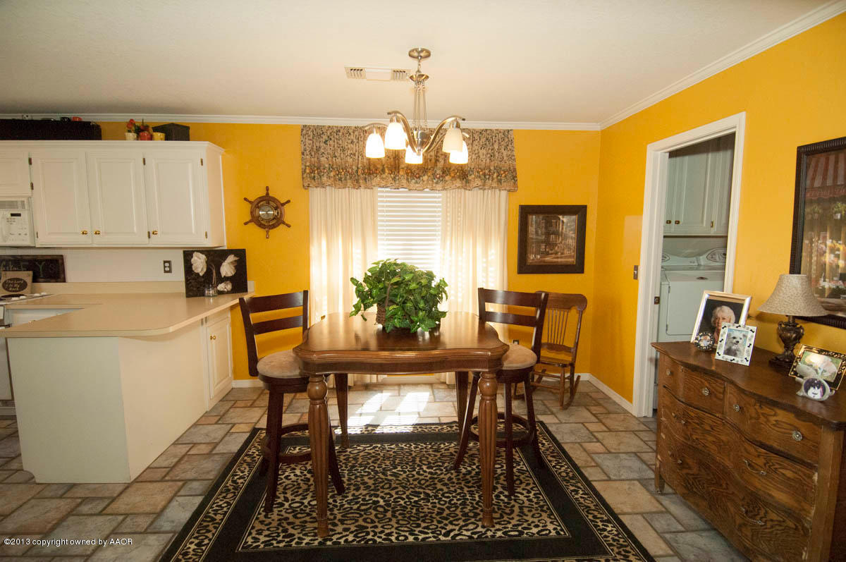 5402 Leo Lane Amarillo, TX 79110 - Photo 13 of 37 a view of a dining room with furniture a chandelier and wooden floor